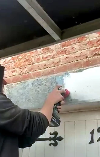 Working on brickwork beside a gate