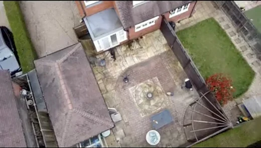 Aerial view of a paved patio and garden