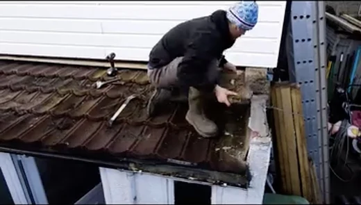 Repair work at the edge of a tiled roof